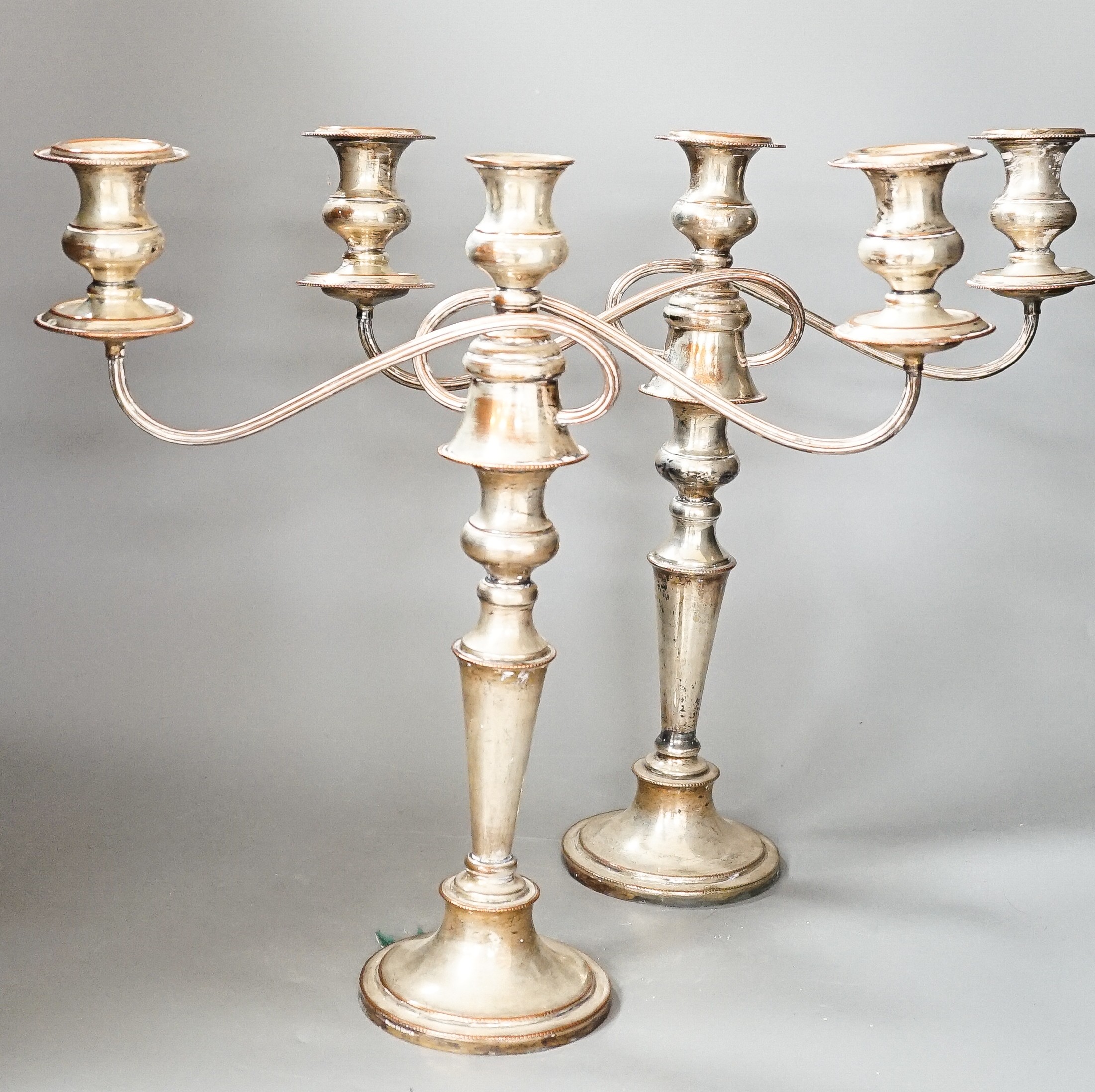 A pair of electroplate on copper free branch candelabra, 40 cms high.